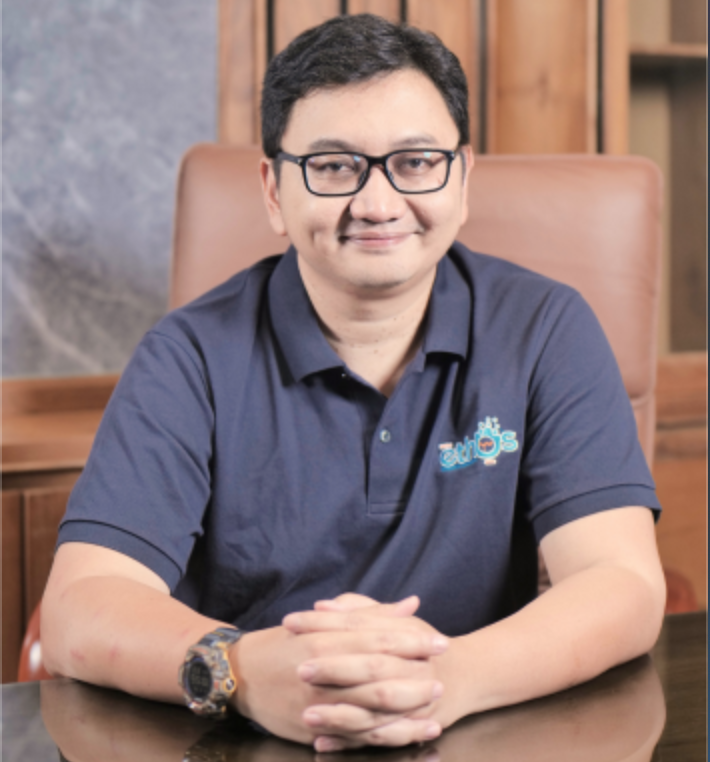 Professional headshot of Indonesian female executive in smart business attire, warm smile, office background