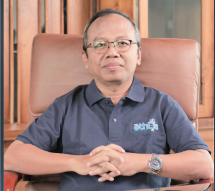 Professional headshot of young Indonesian male marketing professional, casual smart attire, bright background