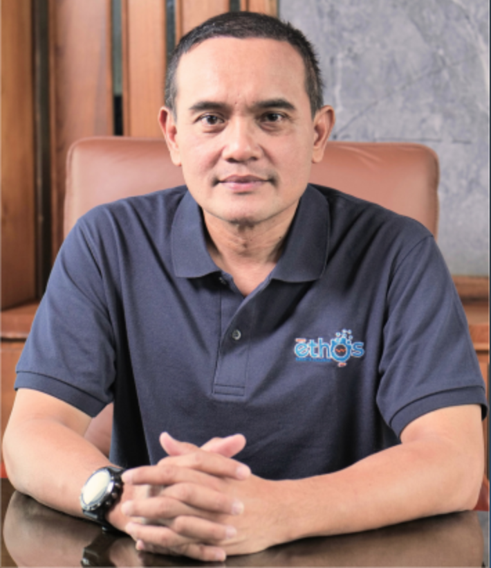 Professional headshot of Indonesian female product manager, modern office setting, professional attire